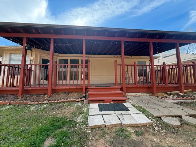 a view of a backyard with wooden floor and outdoor seating