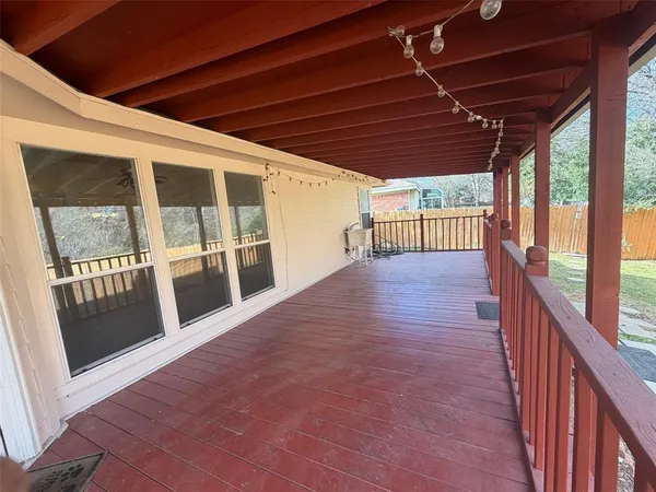 a view of porch with wooden floor and floor to ceiling window