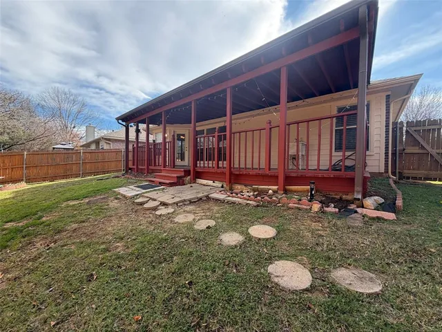 a view of a backyard with table and chairs