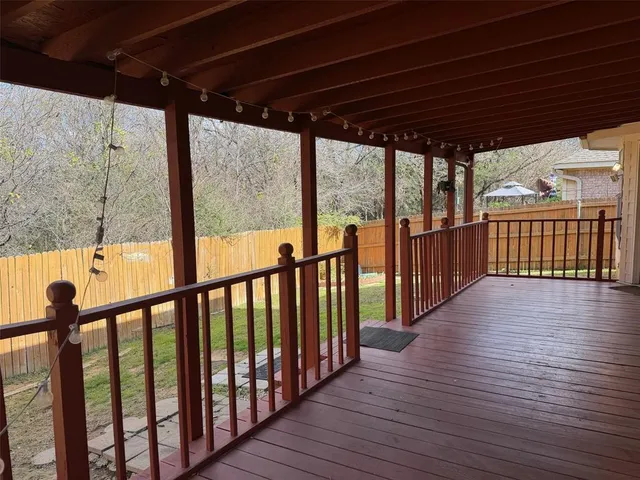 a view of a porch with wooden floor
