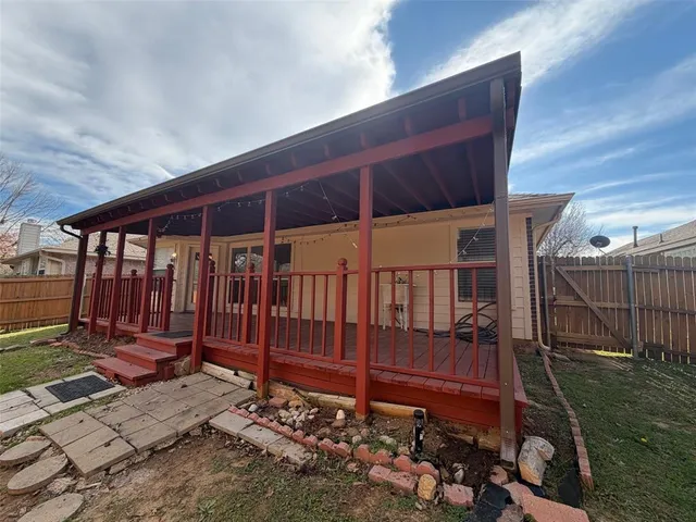 a view of a backyard with wooden fence
