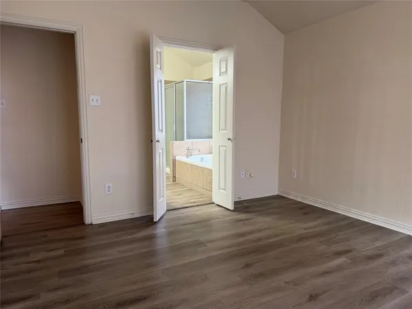 a view of an empty room and wooden floor