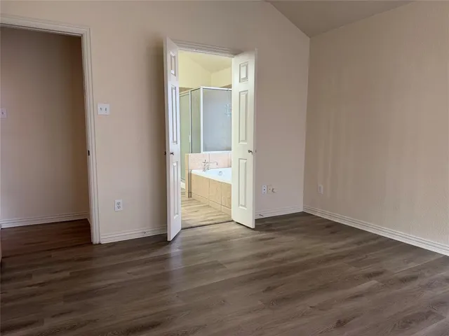 a view of an empty room and wooden floor