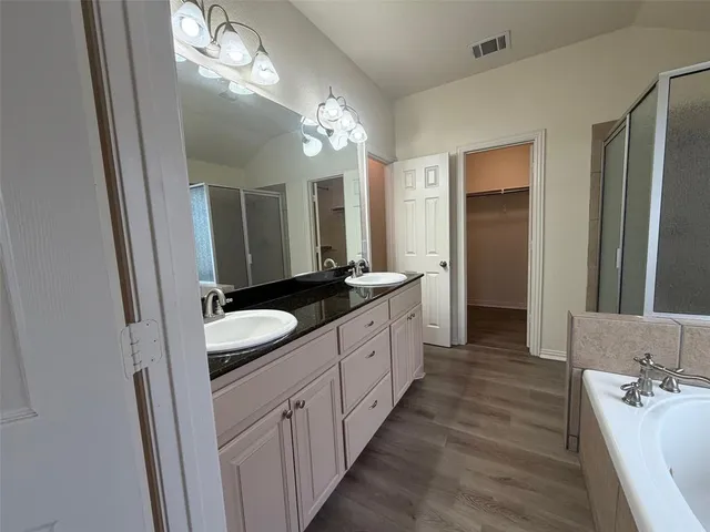 a large bathroom with a double vanity sink and a mirror