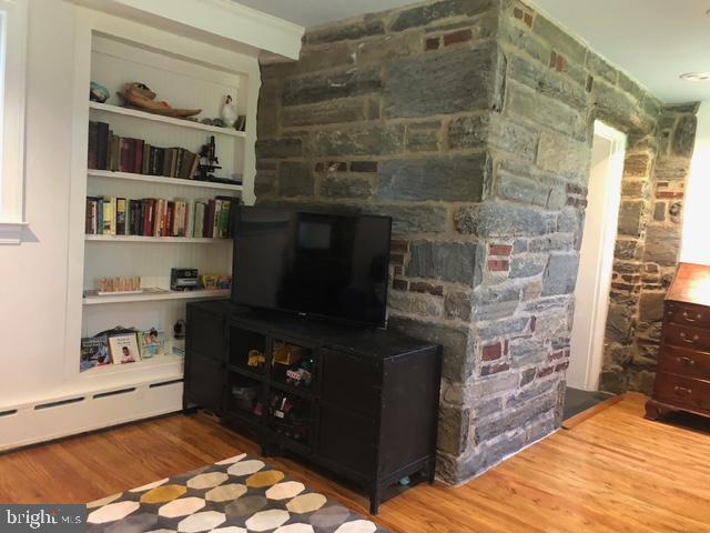 12 Windsor Circle Springfield, PA 19064 - Photo 11 of 28 a living room with a fireplace and a walk in closet