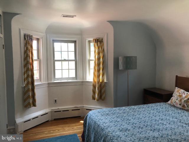 12 Windsor Circle Springfield, PA 19064 - Photo 18 of 28 a bedroom with a bed and wooden floor