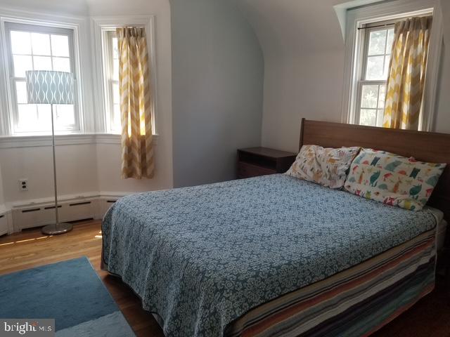 12 Windsor Circle Springfield, PA 19064 - Photo 19 of 28 a bedroom with a bed and wooden floor
