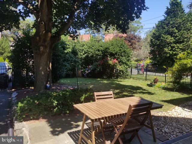 12 Windsor Circle Springfield, PA 19064 - Photo 3 of 28 a view of a patio with table and chairs potted plants and a large tree