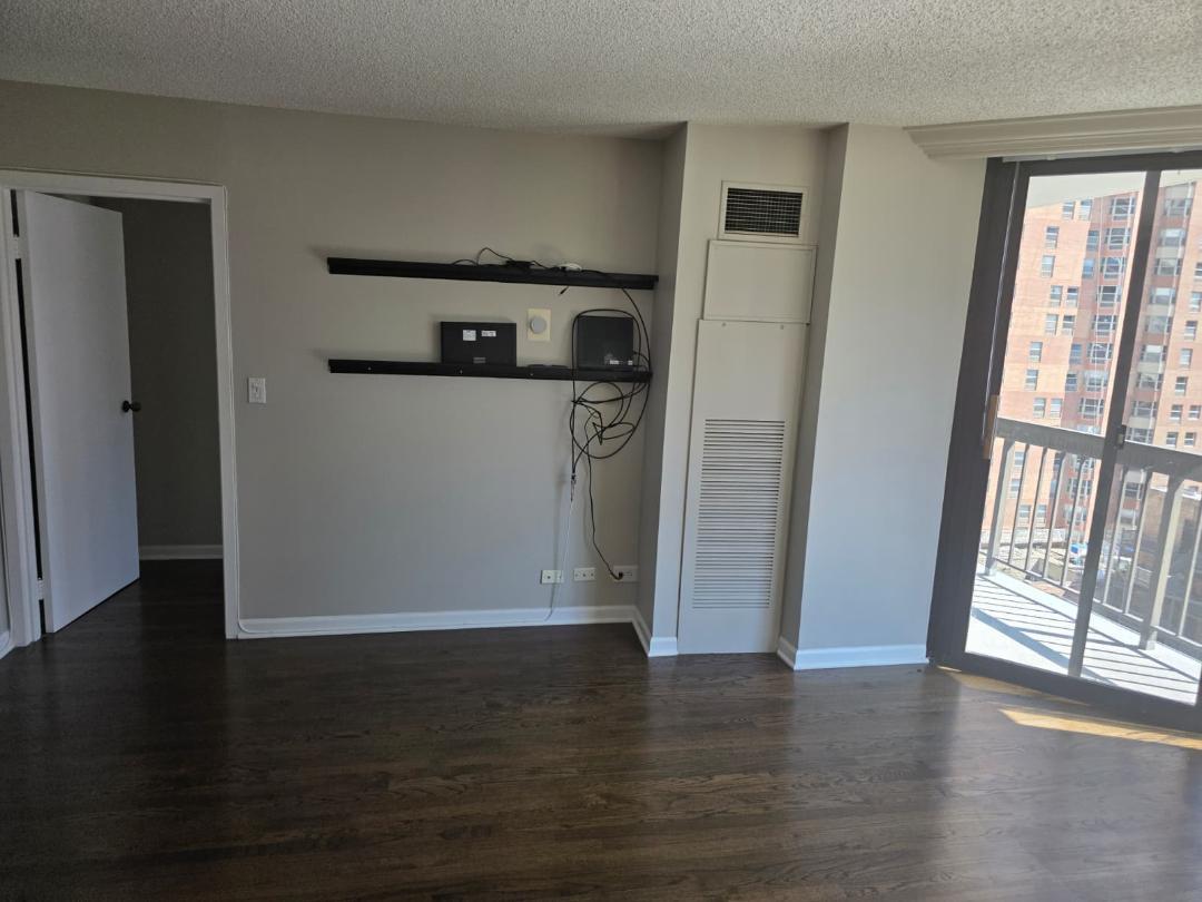 33 West Delaware Place, Unit 10G Chicago, IL 60610 - Photo 8 of 11 a view of empty room with wooden floor and fan