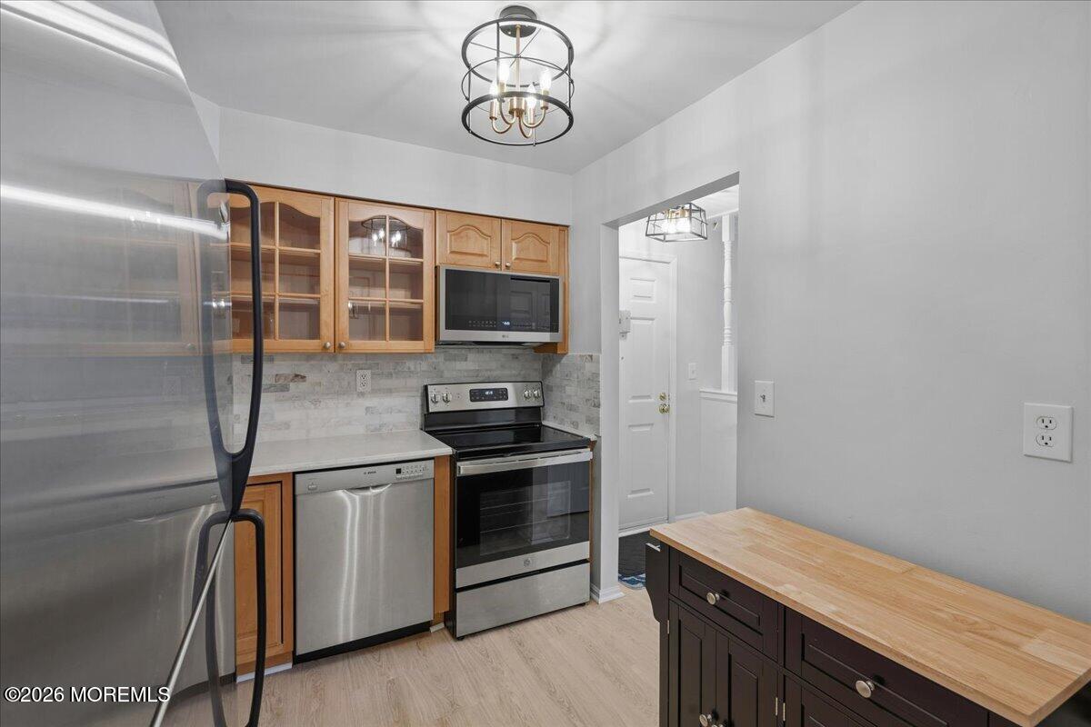 405 Wellington Place Matawan, NJ 07747 - Photo 15 of 29 a kitchen with stainless steel appliances granite countertop a stove and a refrigerator