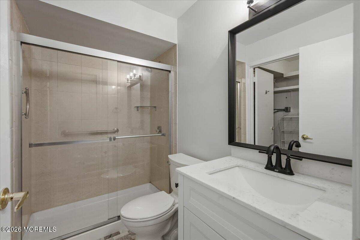 405 Wellington Place Matawan, NJ 07747 - Photo 16 of 29 a bathroom with a sink a toilet and a mirror