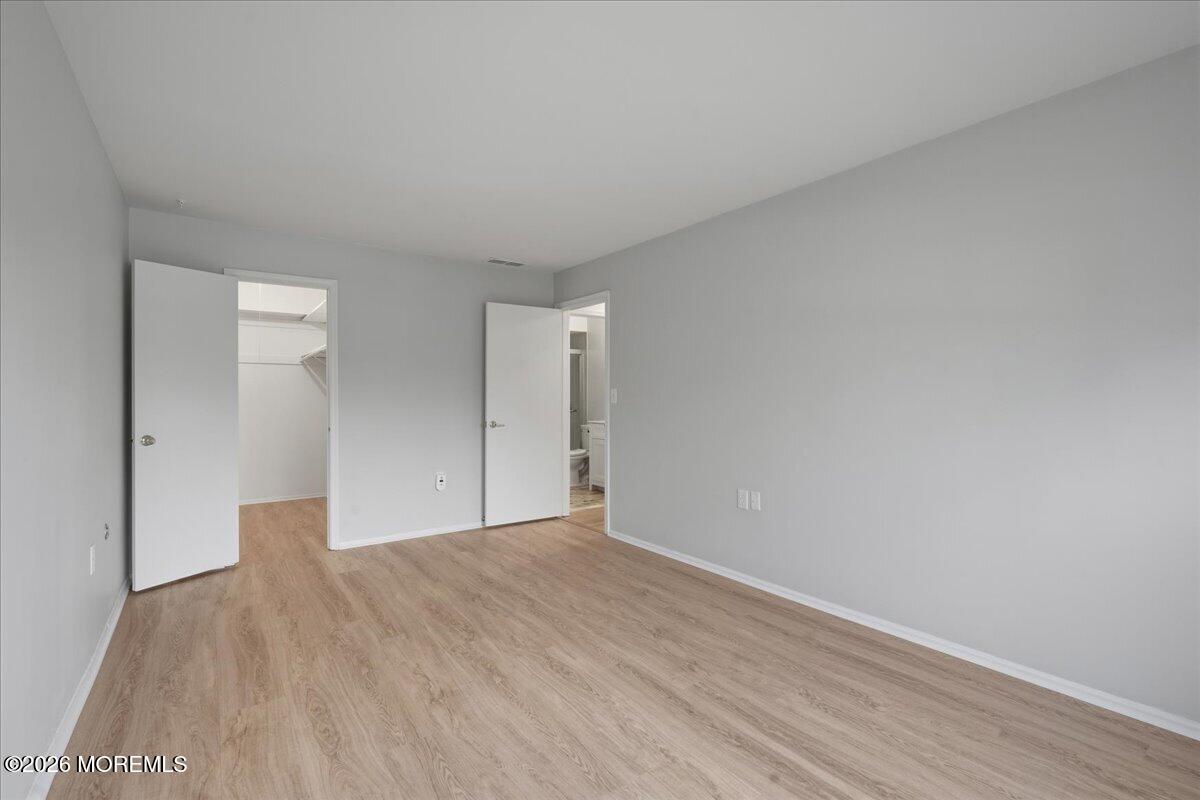 405 Wellington Place Matawan, NJ 07747 - Photo 21 of 29 a view of an empty room with wooden floor
