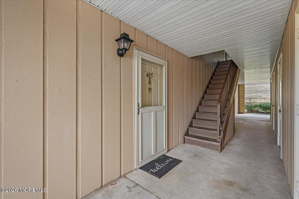 405 Wellington Place Matawan, NJ 07747 - Photo 29 of 29 a view of a hallway with wooden walls and entryway