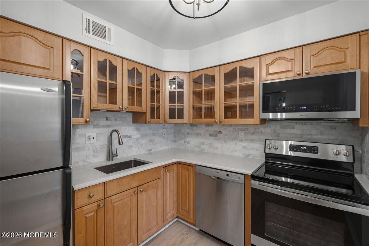 405 Wellington Place Matawan, NJ 07747 - Photo 3 of 29 a kitchen with stainless steel appliances granite countertop a refrigerator and a stove top oven