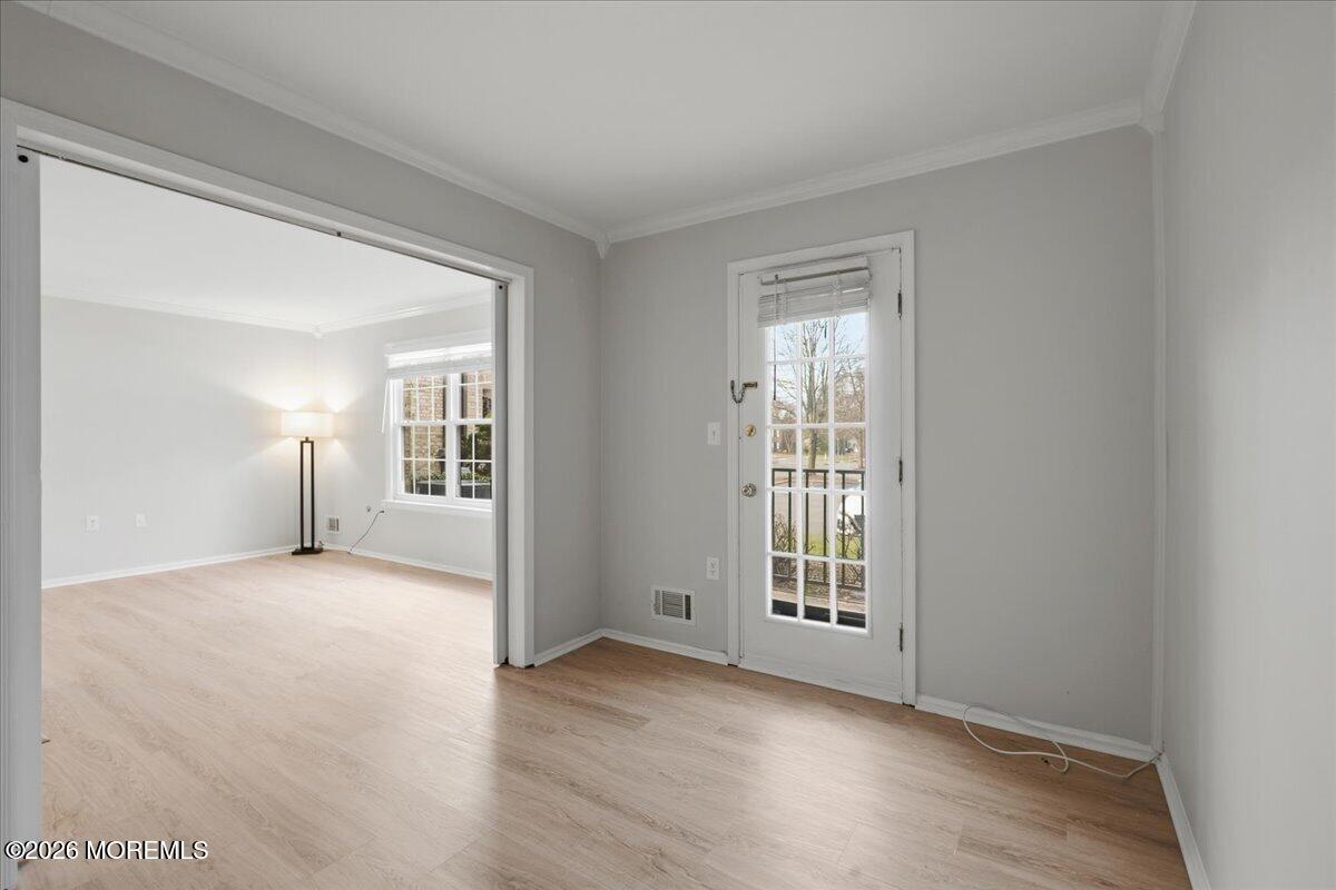 405 Wellington Place Matawan, NJ 07747 - Photo 7 of 29 a view of an empty room with wooden floor and a window