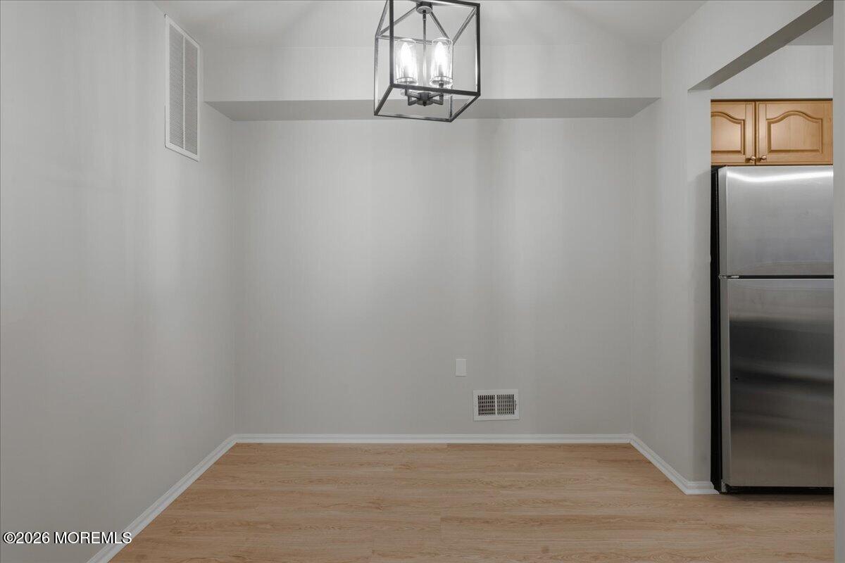 405 Wellington Place Matawan, NJ 07747 - Photo 8 of 29 a view of a room with an empty space and wooden floor