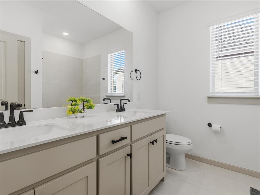 9533 Keep Street Frisco, TX 75035 - Photo 28 of 40 Dual vanity with integrated sinks and black matte fixtures