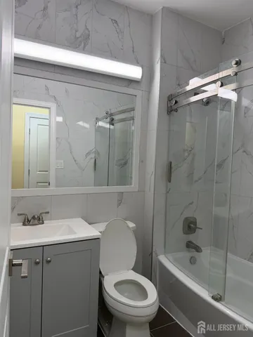 a kitchen with stainless steel appliances granite countertop a stove and a wooden floors