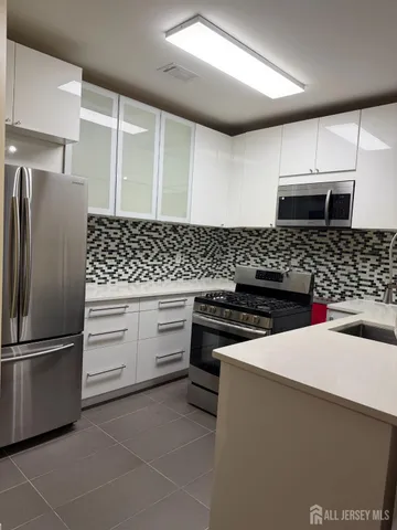 a kitchen with stainless steel appliances and cabinets