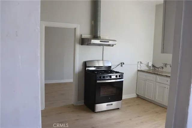 a kitchen with stainless steel appliances granite countertop a stove and a refrigerator