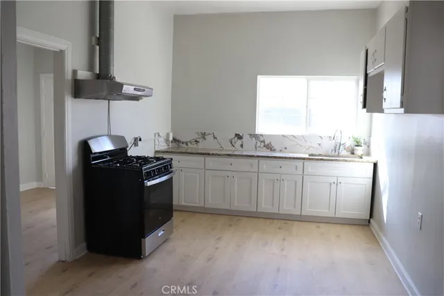 a kitchen with a sink a counter space and appliances