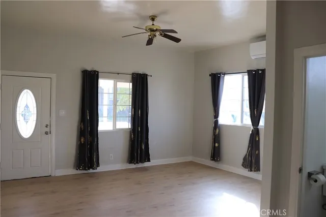 an empty room with windows and closet