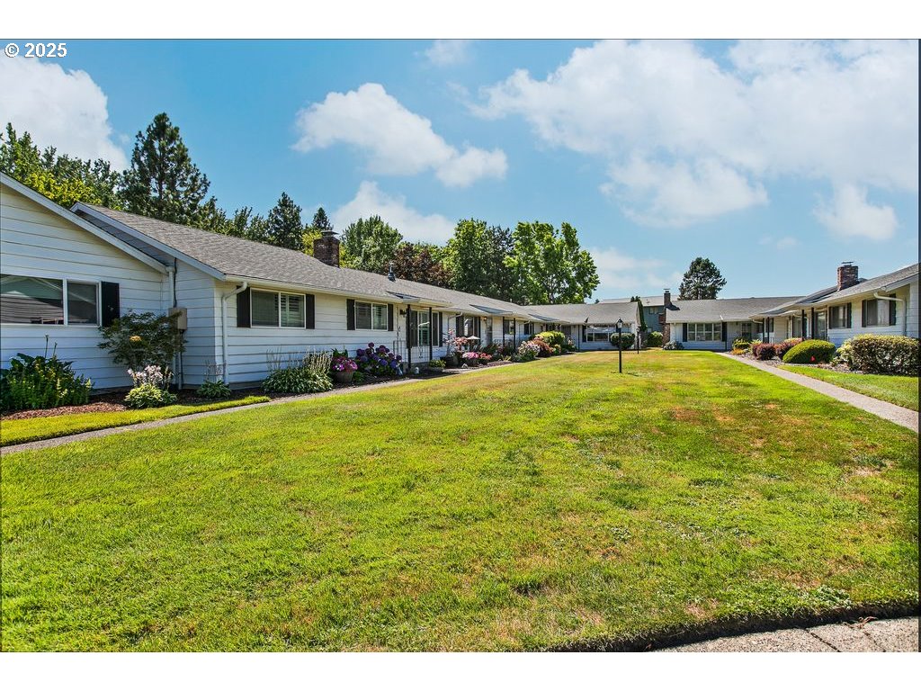 569 Northeast Fleming Avenue Gresham, OR 97030 - Photo 2 of 32 a view of swimming pool with outdoor seating and garden