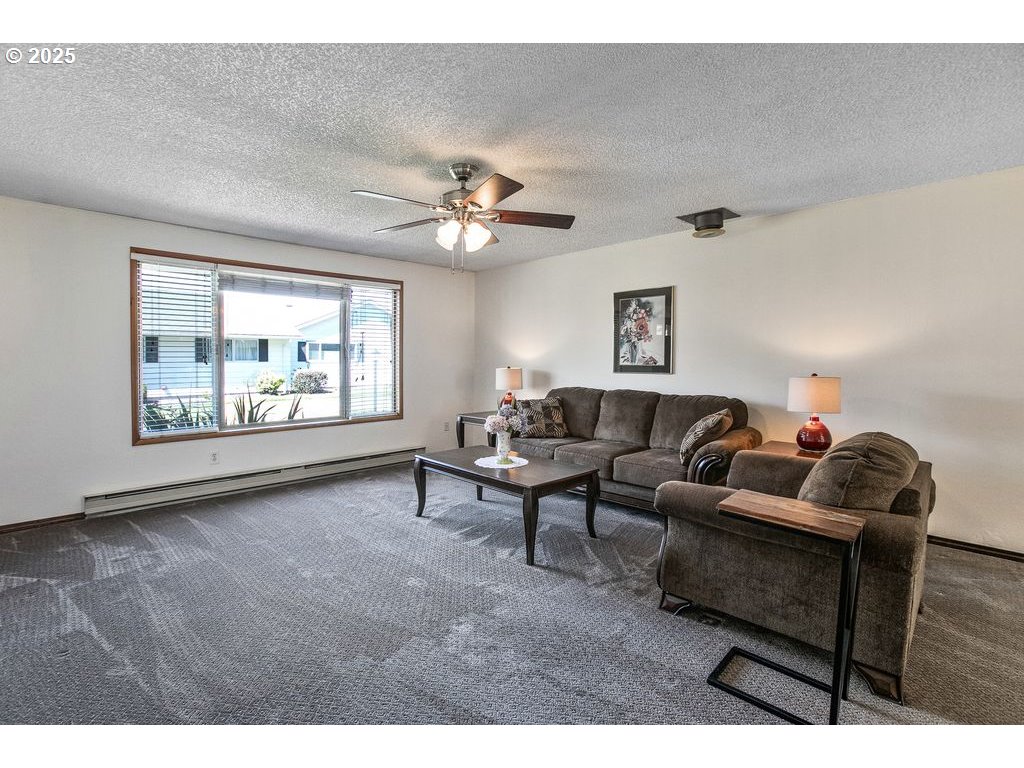 569 Northeast Fleming Avenue Gresham, OR 97030 - Photo 4 of 32 a living room with furniture and a large window