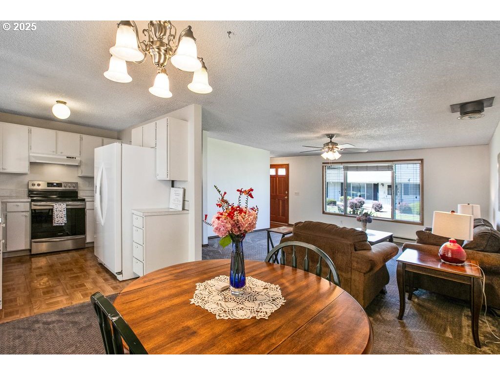 569 Northeast Fleming Avenue Gresham, OR 97030 - Photo 7 of 32 a living room with furniture and a chandelier