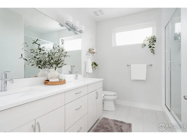 a bed room with a bed and a painting on the wall