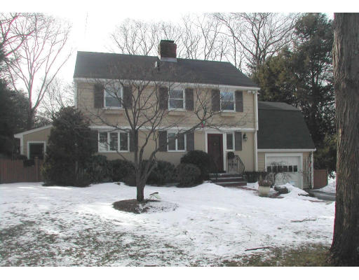 a front view of a house with yard covered in snow