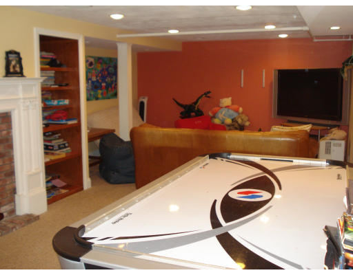 49 Madison Road Wellesley, MA 02481 - Photo 15 of 18 a room with furniture and a flat screen tv