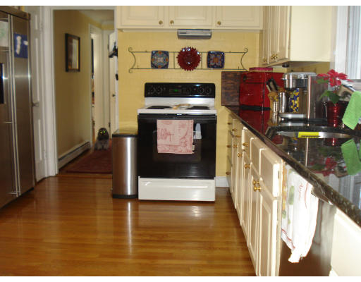 49 Madison Road Wellesley, MA 02481 - Photo 5 of 18 a view of a kitchen with stainless steel appliances granite countertop a stove a refrigerator and wooden floor