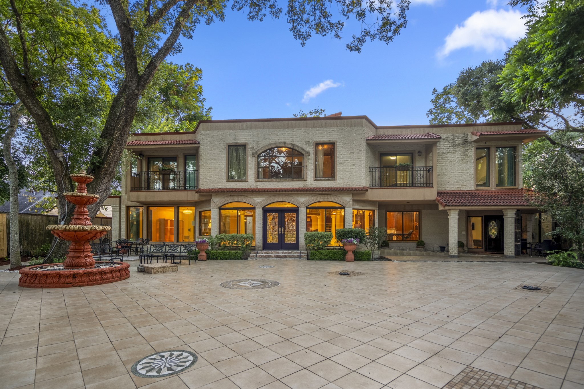Welcome to a true West University treasure. This grand Spanish Mediterranean estate invites you in with a sweeping tiled courtyard, cantera columns, and the warmth of mature shade trees.