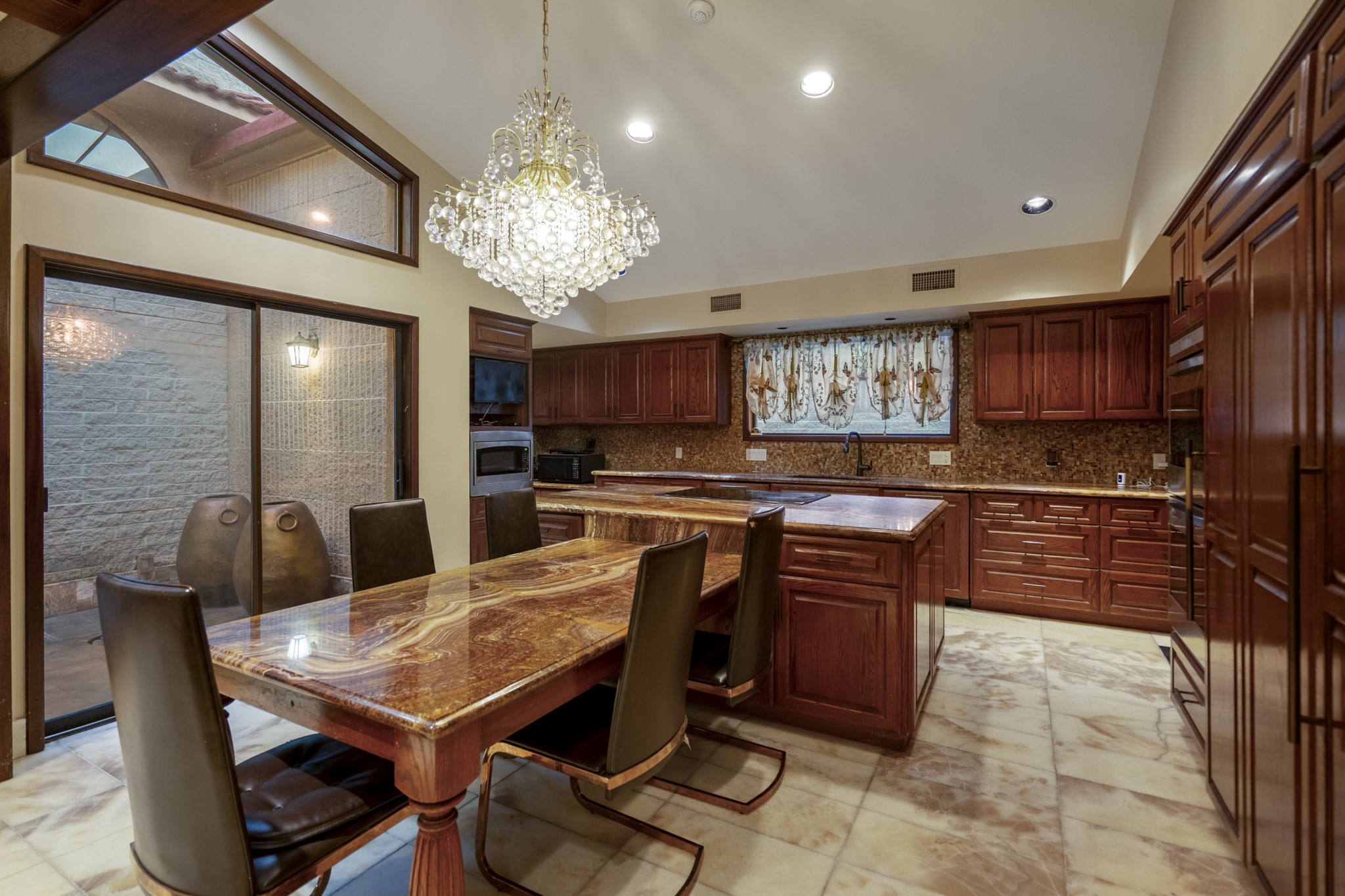 6535 Buffalo Speedway Houston, TX 77005 - Photo 12 of 34 The central island offers both workspace and seating, making this kitchen the perfect place to prep, serve, and connect.