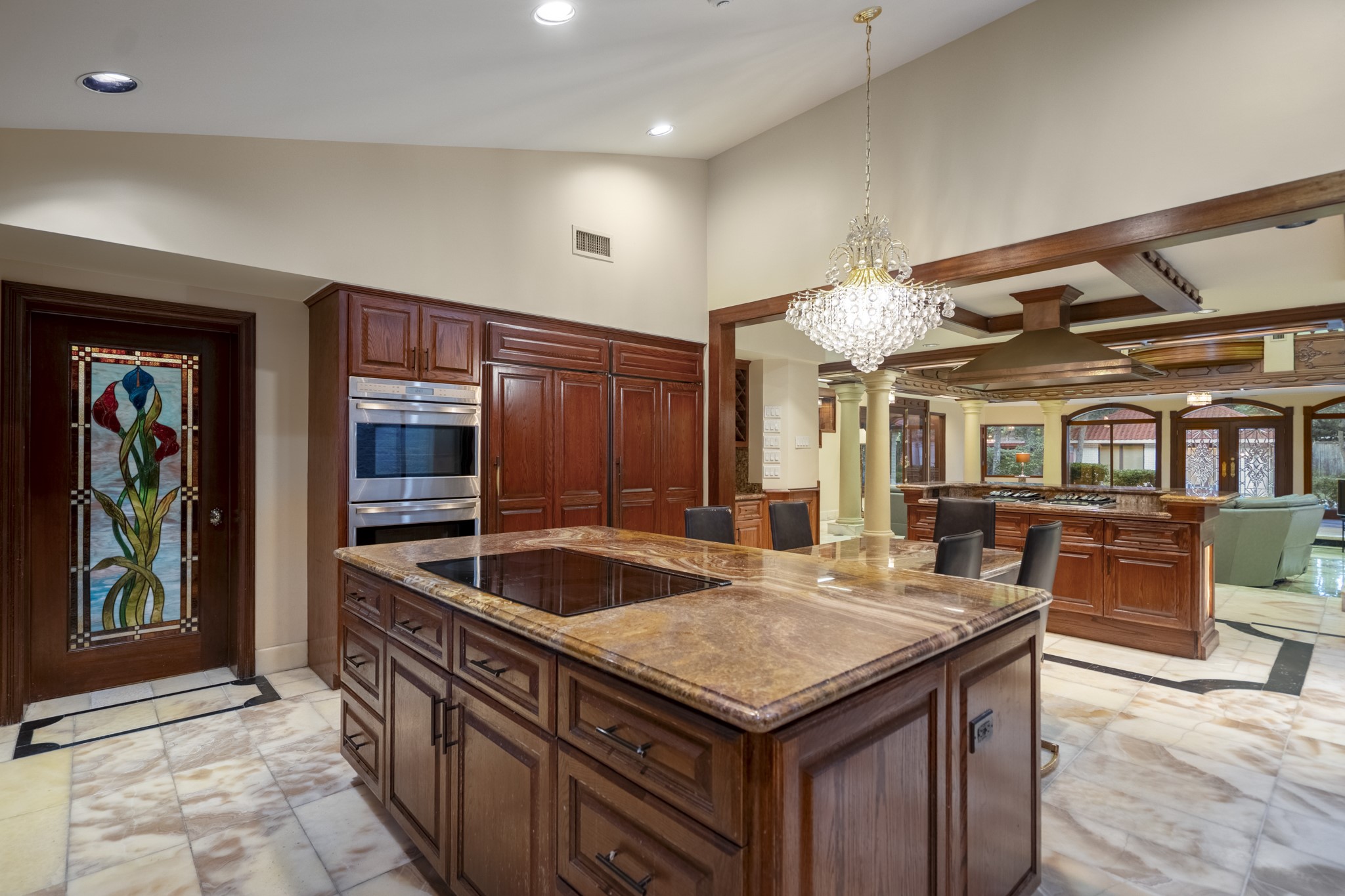 6535 Buffalo Speedway Houston, TX 77005 - Photo 13 of 34 A closer look at the kitchen’s dual-island layout reveals premium materials, illuminated stone details, and ample space for cooking, gathering, and entertaining.