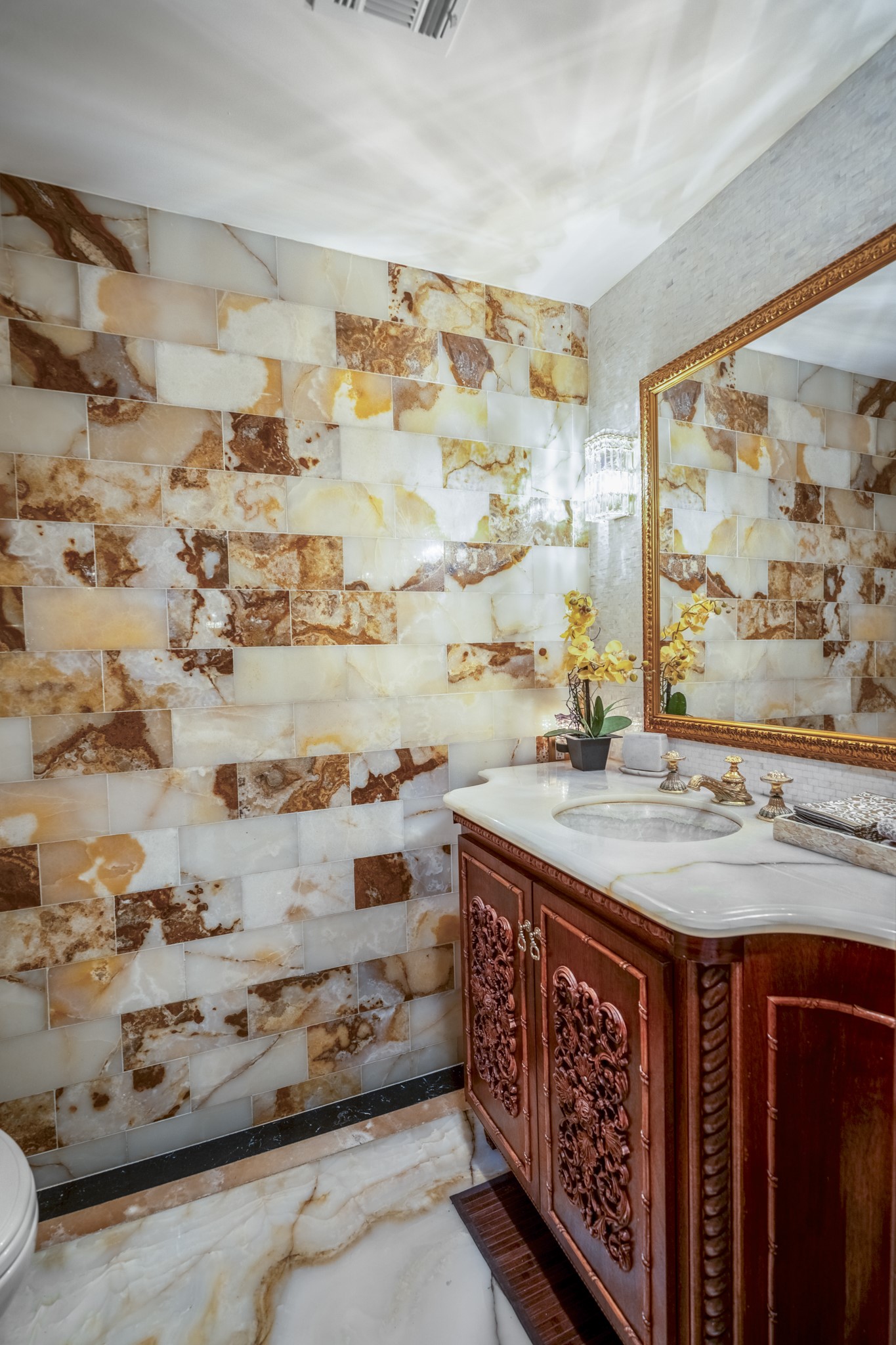 6535 Buffalo Speedway Houston, TX 77005 - Photo 17 of 34 The redesigned powder bath is a jewel box of design, featuring striking tilework, a custom vanity, and designer finishes that make a bold yet elegant statement.