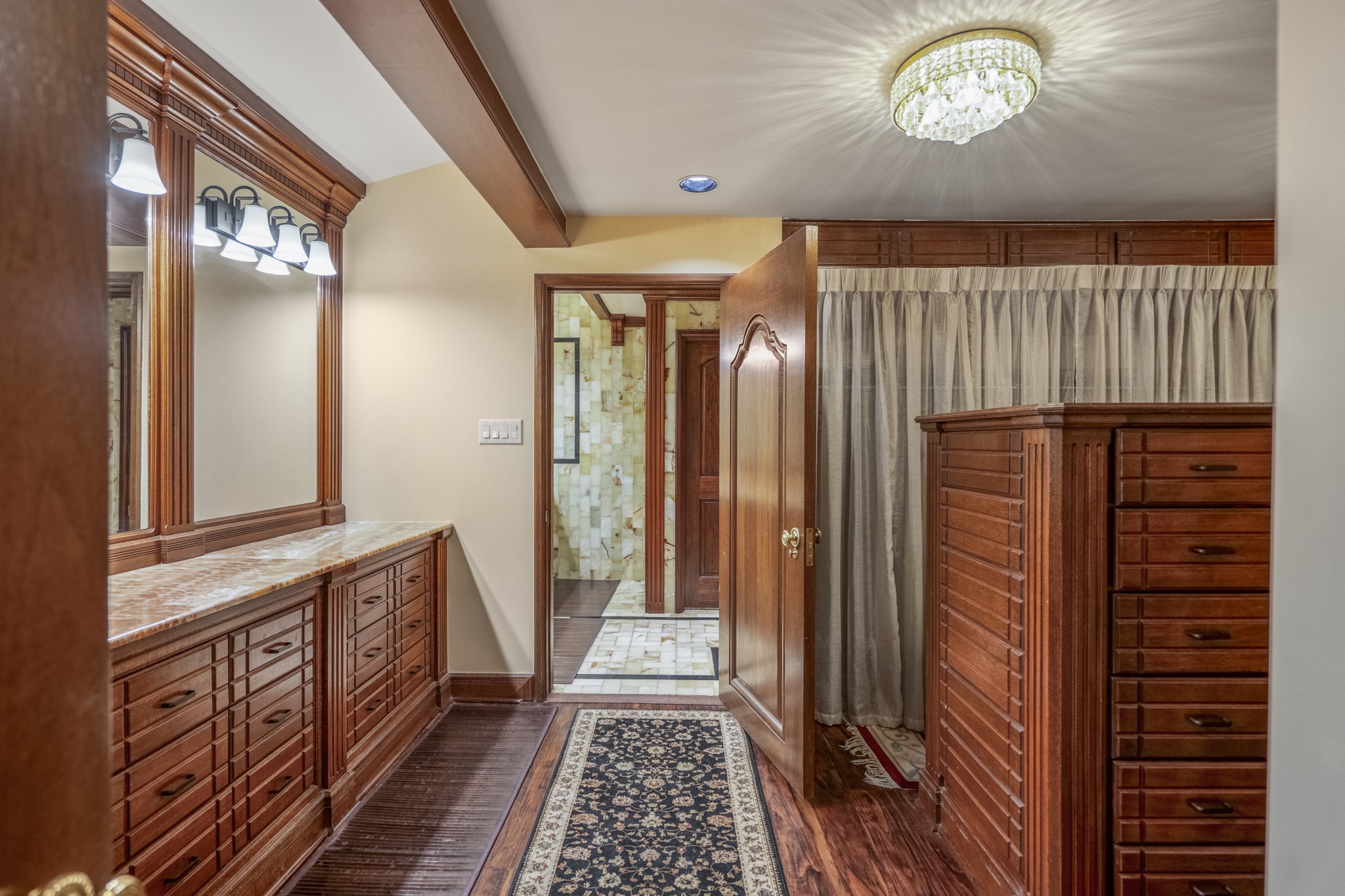 6535 Buffalo Speedway Houston, TX 77005 - Photo 23 of 34 The primary closet offers extensive built-in storage, shelving, and display space, making organization both elegant and effortless.