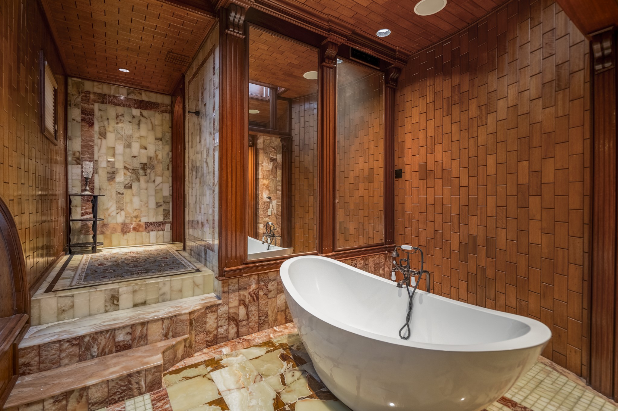 6535 Buffalo Speedway Houston, TX 77005 - Photo 25 of 34 The spa-like primary bathroom features onyx & marble surfaces, freestanding soaking tub, and exquisite tilework throughout.