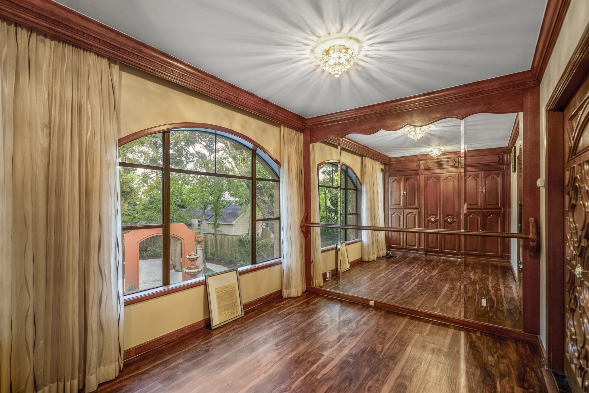 6535 Buffalo Speedway Houston, TX 77005 - Photo 27 of 34 One of many versatile flex spaces in the home, this dedicated dance room features a mirrored wall and ballet barre, making it ideal for dance, fitness, or personal wellness routines.