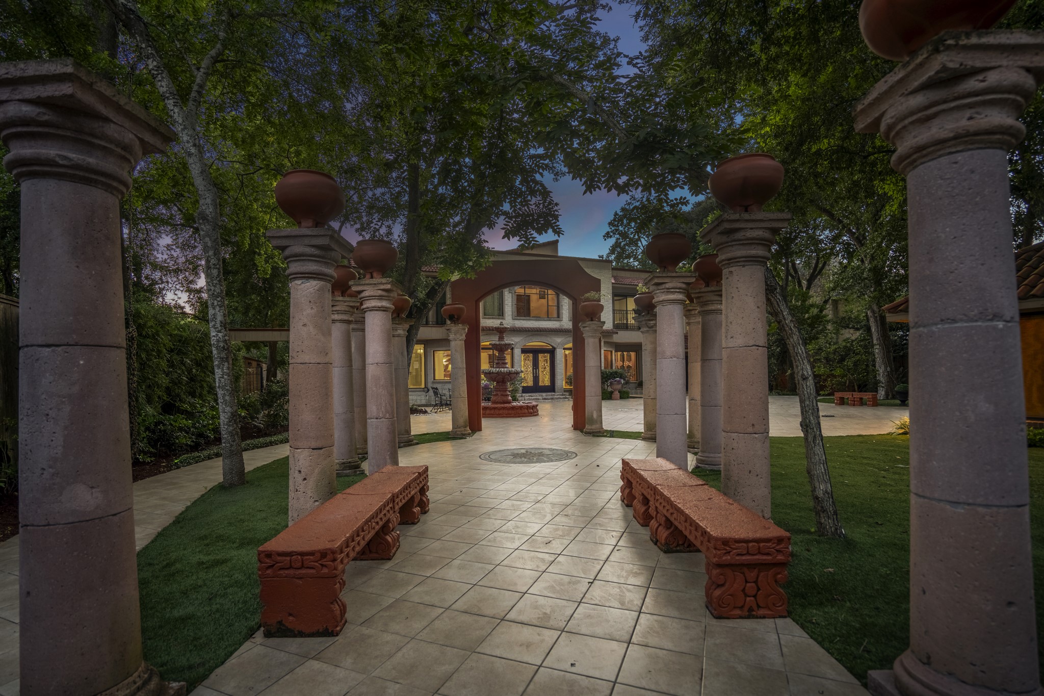 6535 Buffalo Speedway Houston, TX 77005 - Photo 33 of 34 A wide-angle view of the backyard reveals its impressive scale, with beautifully installed tilework, low-maintenance turf, and mature trees offering both shade and privacy.