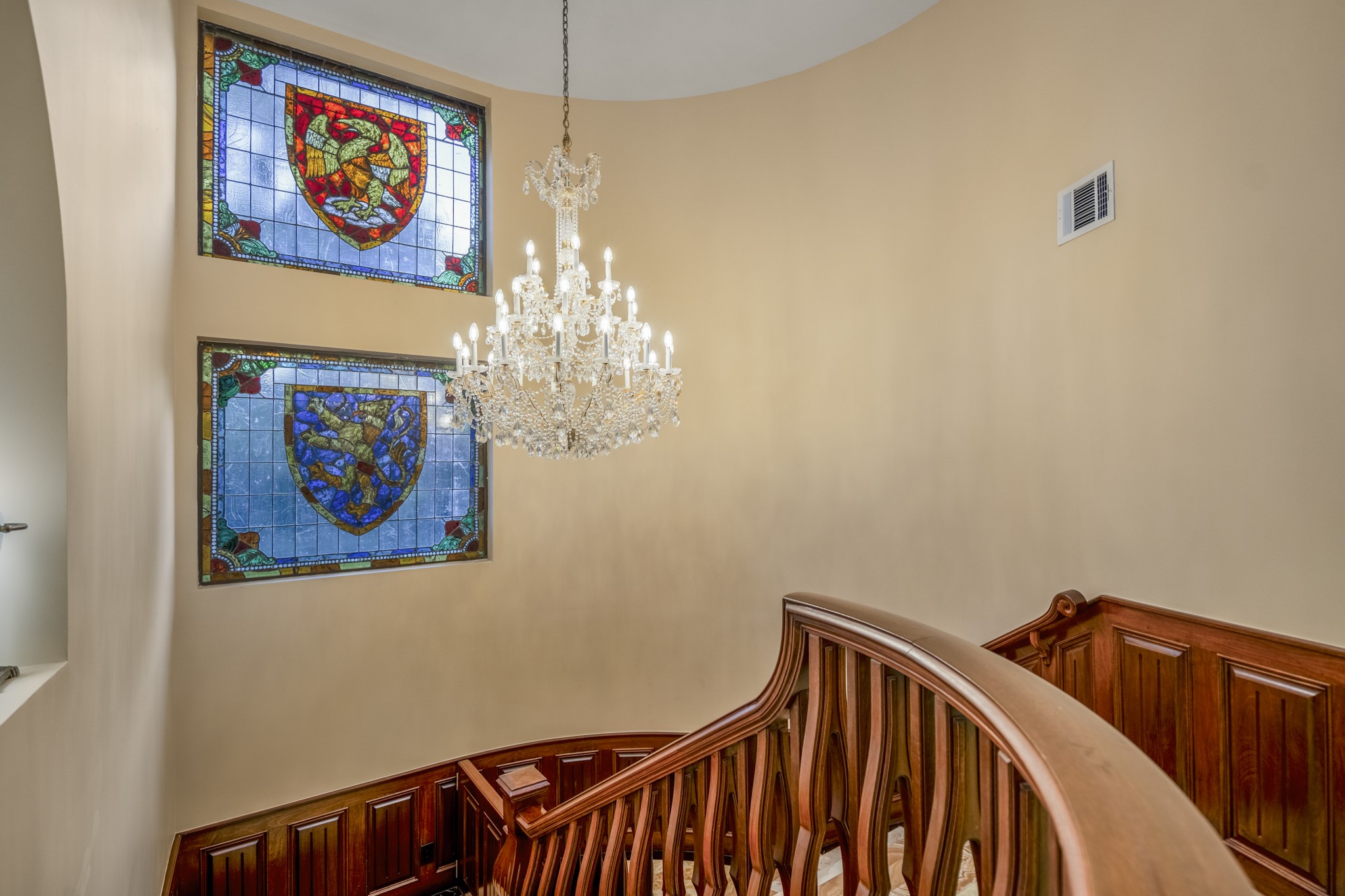 6535 Buffalo Speedway Houston, TX 77005 - Photo 7 of 34 A second-floor vantage point showcases the home’s soaring ceilings, sculptural staircase, and custom wood detailing, all bathed in natural light.