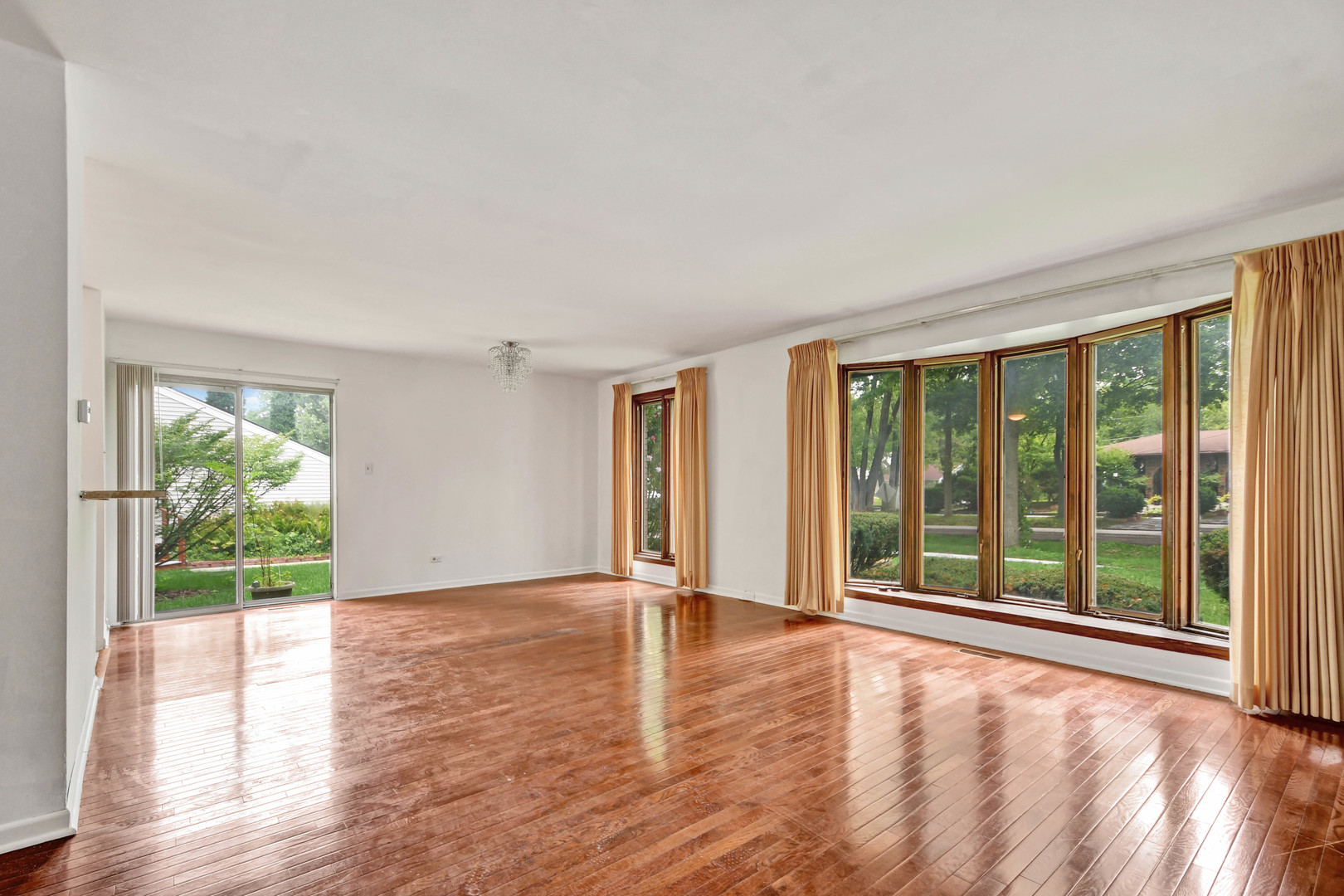 18932 Springfield Avenue Flossmoor, IL 60422 - Photo 2 of 22 a view of an empty room with wooden floor and a window