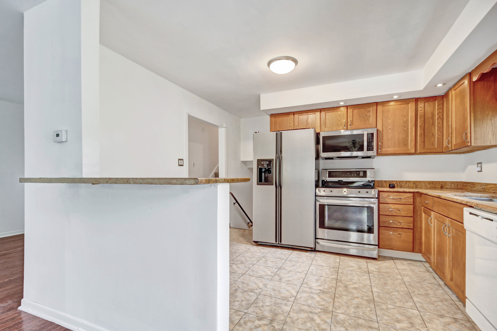 18932 Springfield Avenue Flossmoor, IL 60422 - Photo 6 of 22 a kitchen with white cabinets and stainless steel appliances