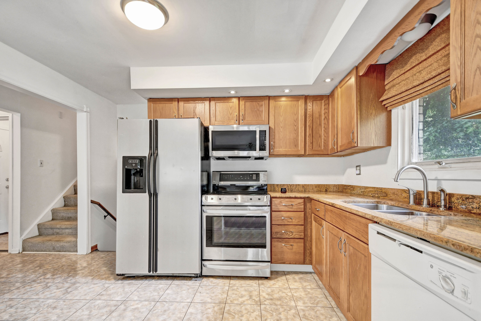 18932 Springfield Avenue Flossmoor, IL 60422 - Photo 7 of 22 a kitchen with stainless steel appliances granite countertop a refrigerator sink and stove