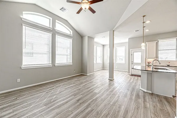 a kitchen with kitchen island granite countertop stainless steel appliances a sink stove and refrigerator