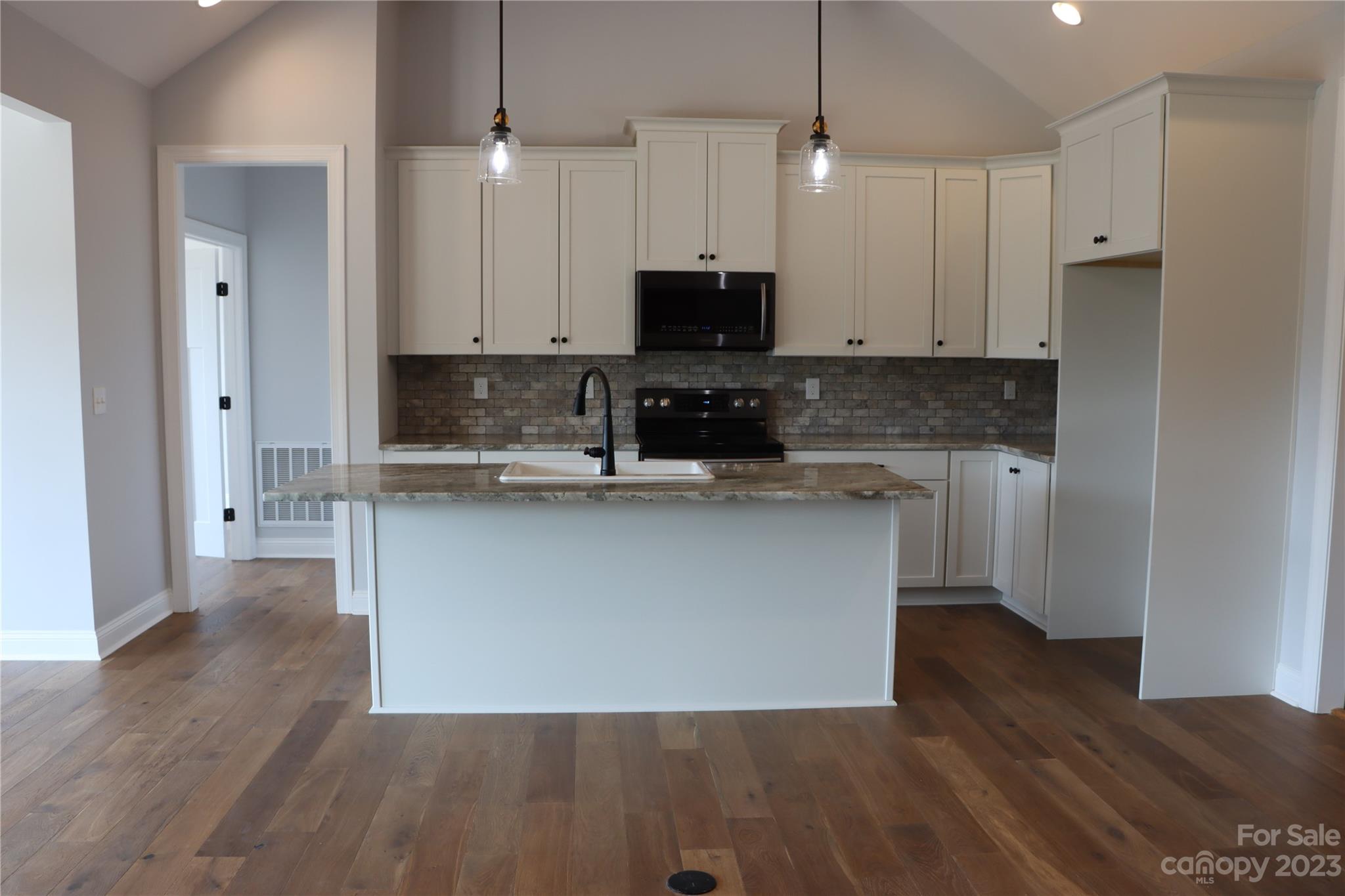 2624 High Ridge Marshville, NC 28103 - Photo 4 of 4 a kitchen with kitchen island a counter top space a sink and cabinets