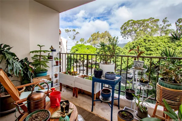 a balcony with furniture and potted plants