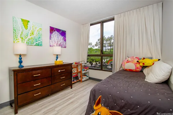 a bed room with a bed and a window