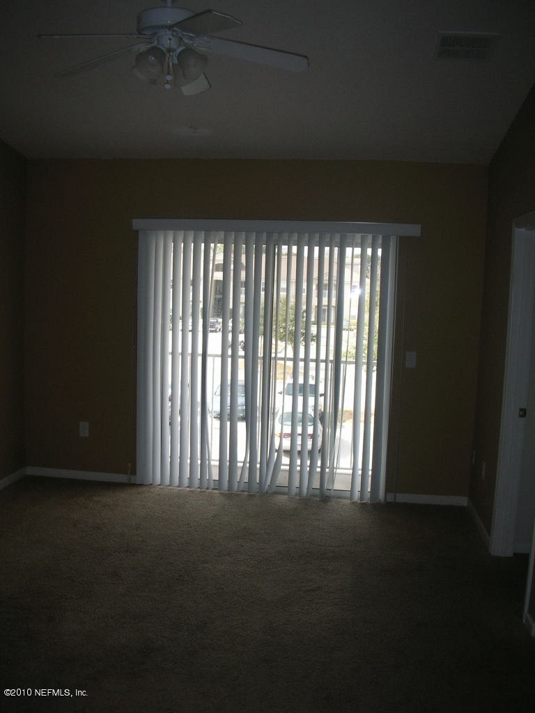 7920 Merrill Road, Unit 813 Jacksonville, FL 32277 - Photo 3 of 8 a view of an empty room with a window